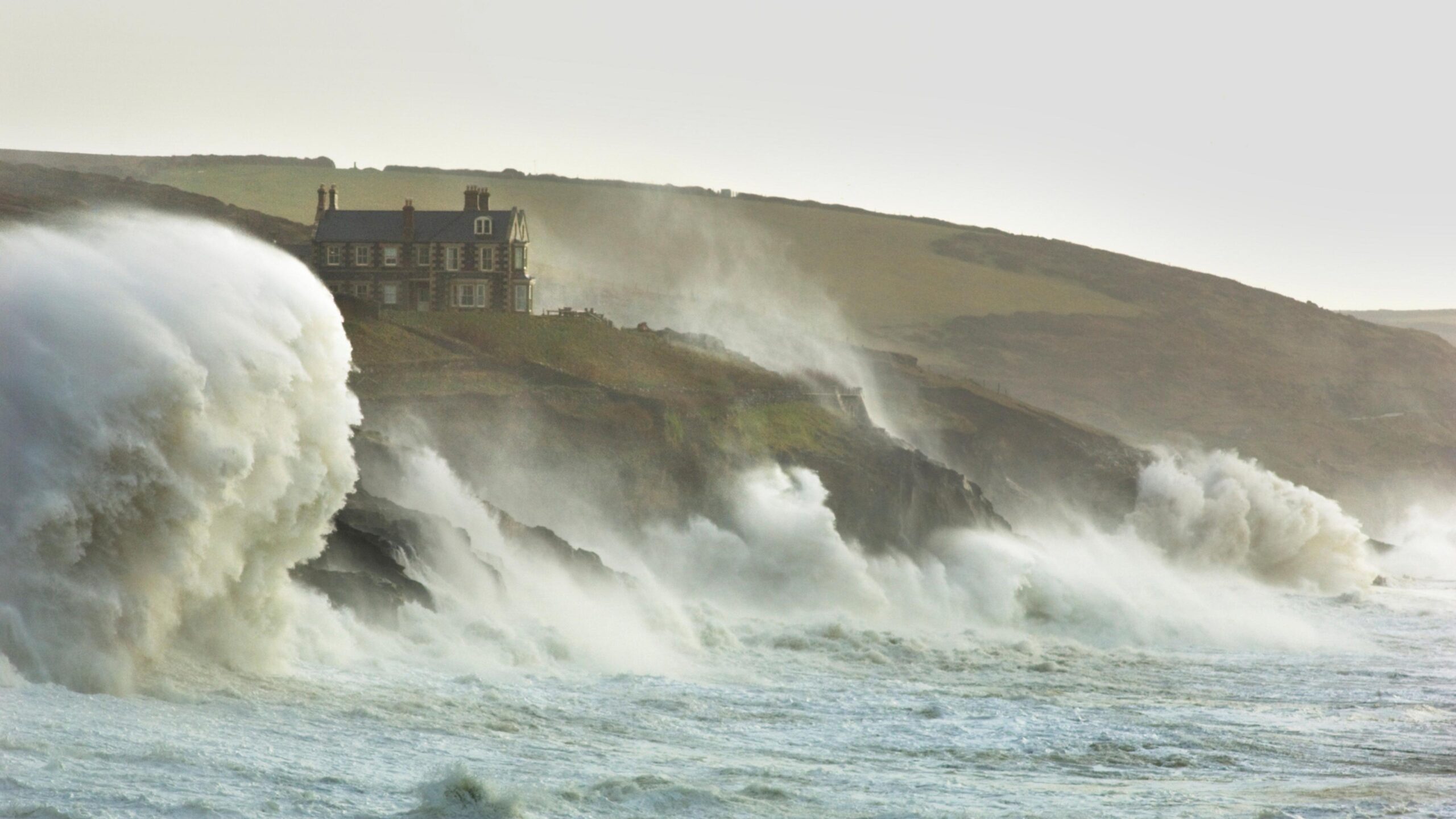 Waves crash against cliffs