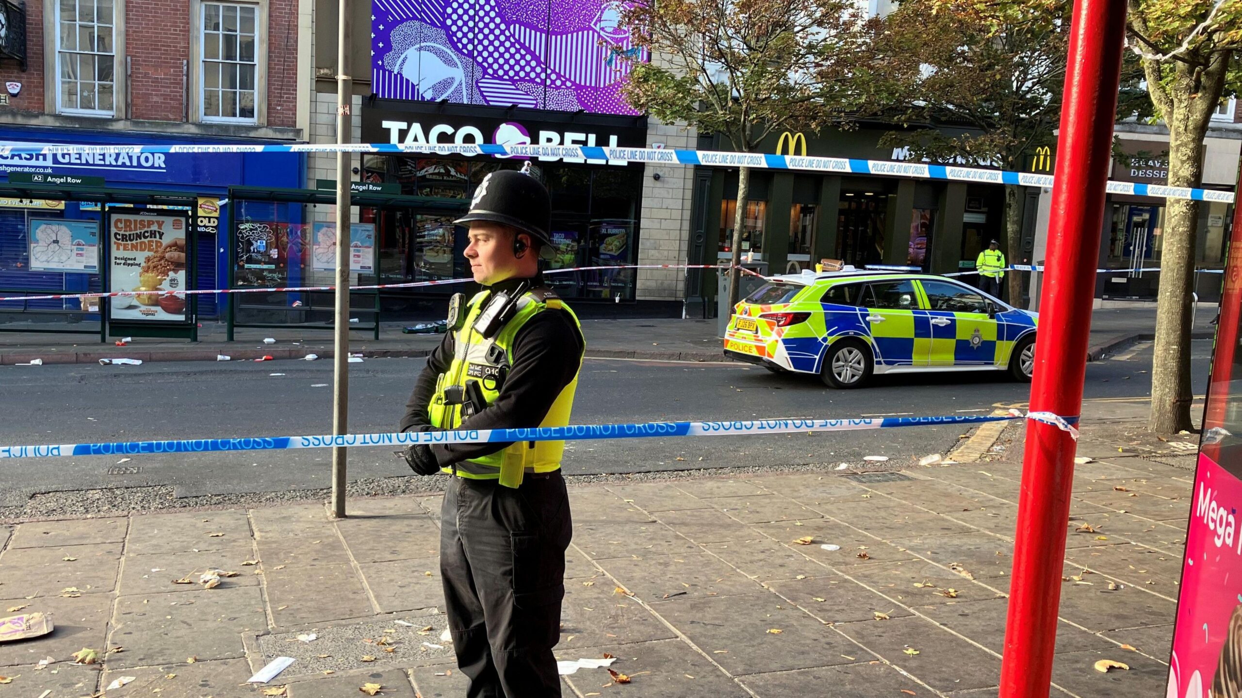 A police officer standing next to a police cordon