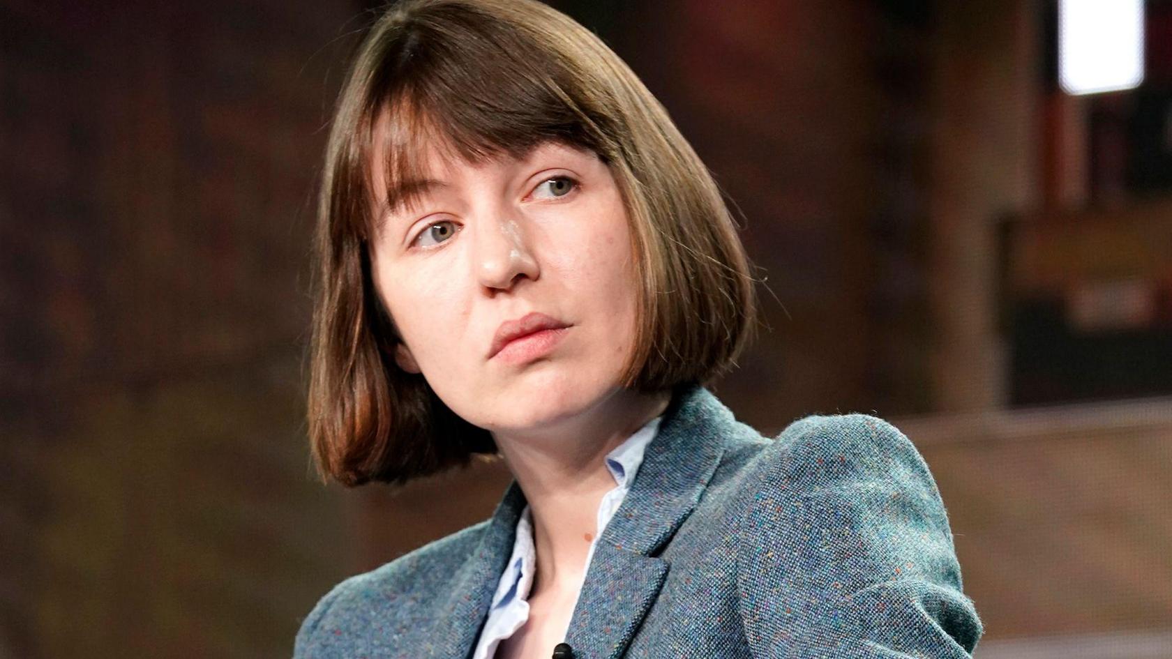 Sally Rooney has a bob style haircut and is wearing a blue blazer