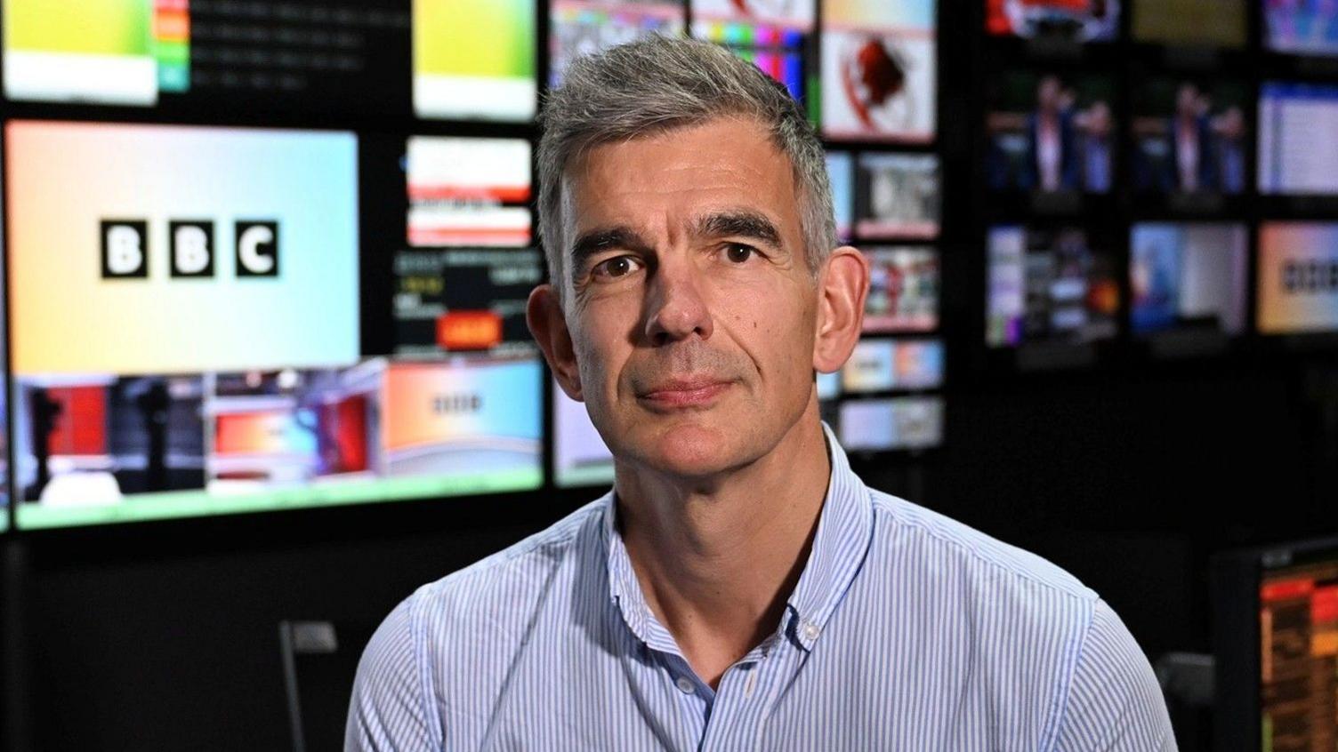 Matt Brittin seen wearing a blue and white striped shirt in a BBC studio