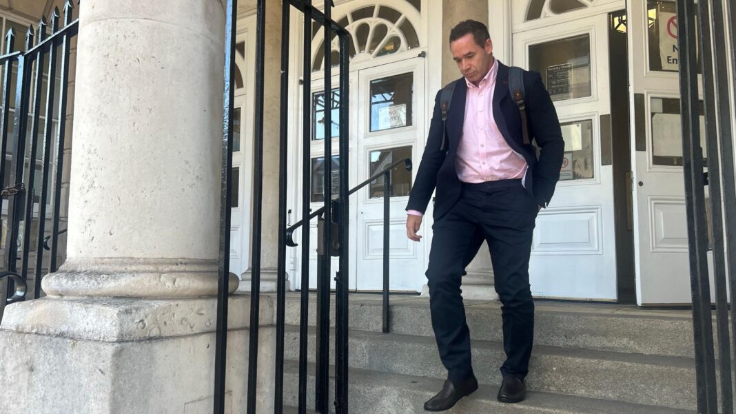Katie Price’s ex told teenager to ‘take it to the grave’, rape trial hears Kieran Hayler pictured leaving Lewes Crown Court on 5 October. Hayler, who is wearing a rucksack, is wearing a dark suit and pink shirt.