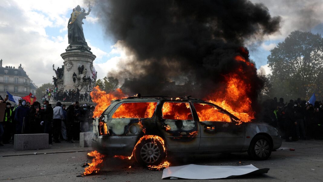 Violent clashes, looting and buildings ablaze in France as over 1,000 arrested after protests A car burns amid clashes between protesters and the French police during a demonstration against the cost of living and rising fuel prices at the Place de la Republique in Paris