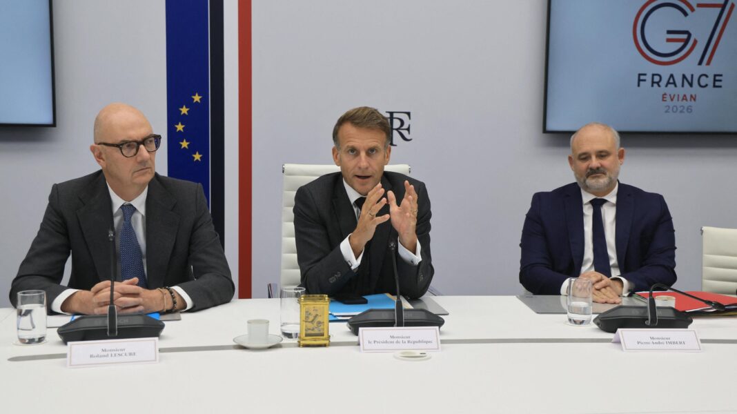 French President Emmanuel Macron (C) speaks next to France's Economy, Finance and Industry Minister Roland Lescure and Secretary-General of the Office of the President of the French Republic Pierre-Andre Imbert following a video conference with G7 leaders