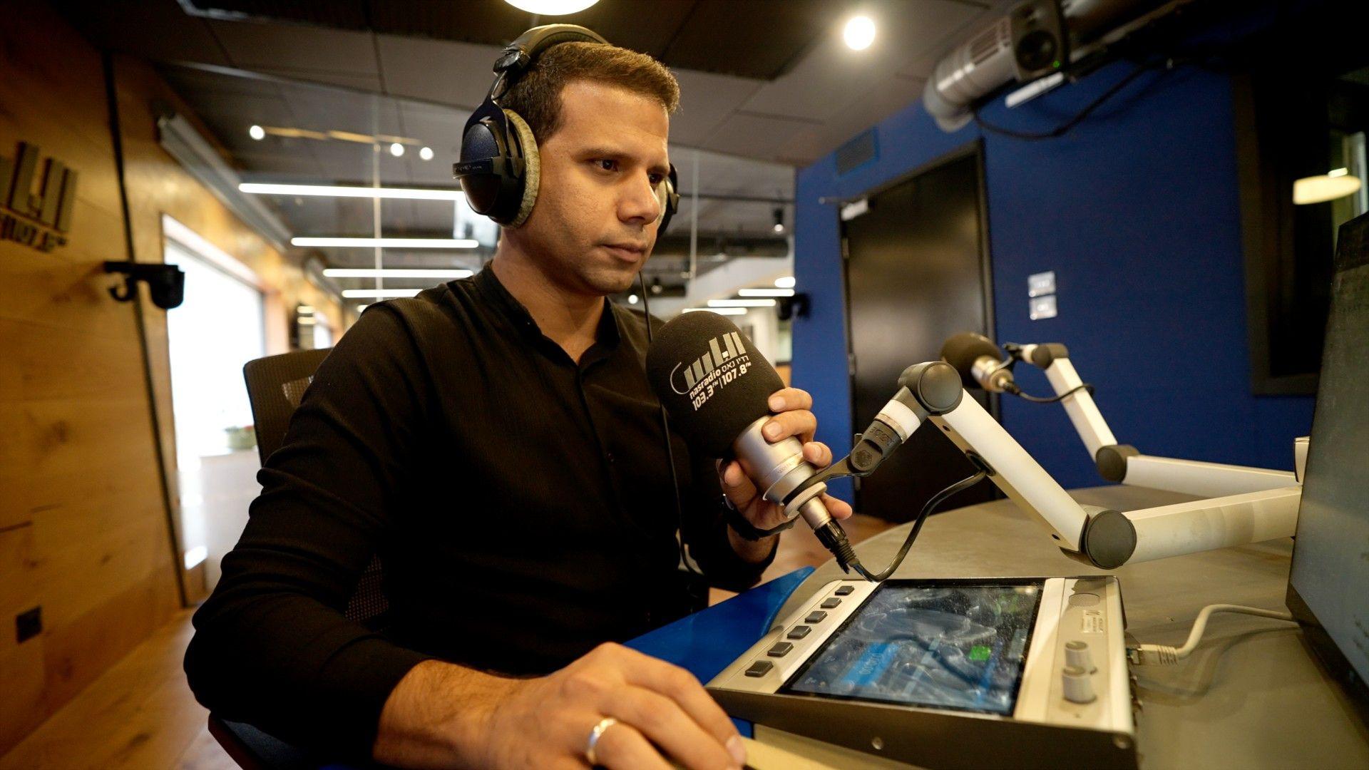 Mohammed Magdali holds a microphone