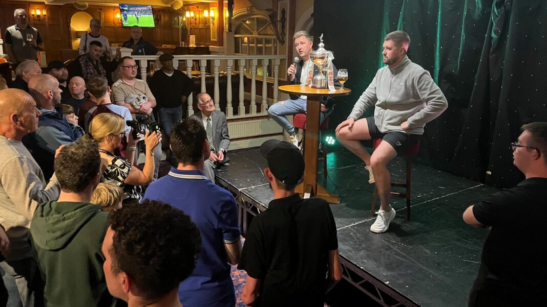 Man jailed for charity theft at snooker star Wilson’s home Kyren Wilson on stage with his trophy at Barratts