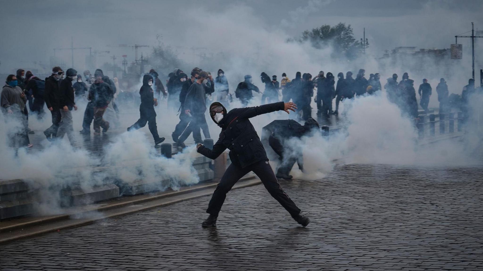 People clash with police during a demonstration against the high cost of living in Bordeaux.