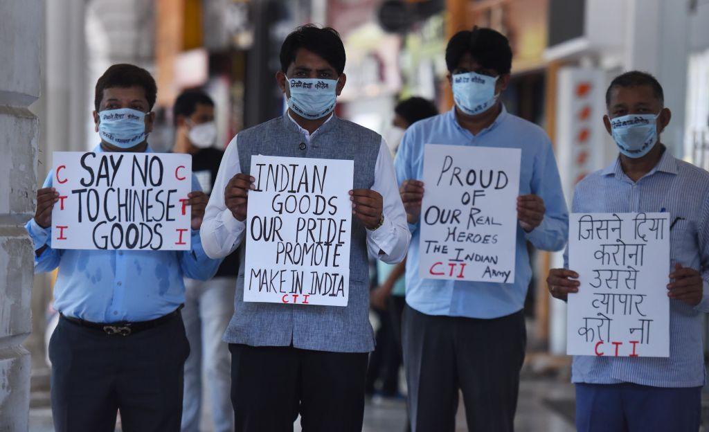 Indian traders in Delhi wearing masks hold placards during a silent protest against China and Chinese products in 2020, after 20 Indian soldiers were killed in the skirmish with Chinese troops in the Galwan Valley.