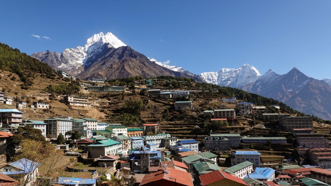 Building boom puts 300,000 people in the path of potential Himalayan disasters Namche Bazaar's colourful rooftops spread across terraced hillsides in Nepal's Everest region, with the snow-capped peak of Mount Thamserku towering above the town under a clear blue sky.