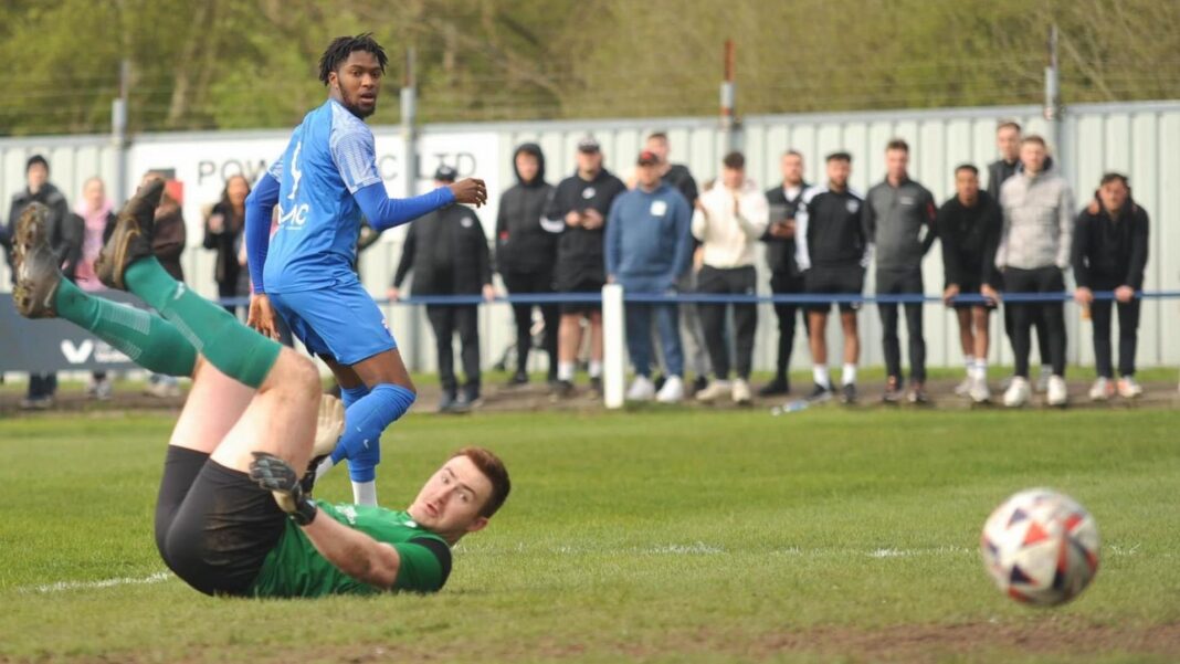 Striker swaps Sunday league for Champions League A player wearing a blue kit fires the ball past a scrambling goalkeeper on a muddy pitch