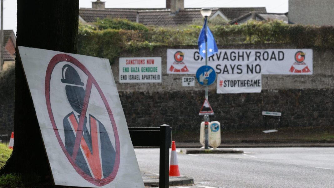 Posters on the Garvaghy Road which say Garvaghy Road Says No. Sanctions Now. End Gaza Genocide and End ISrawel Apartheid along with a poster of an Orangeman with a 'no go' sign over it.