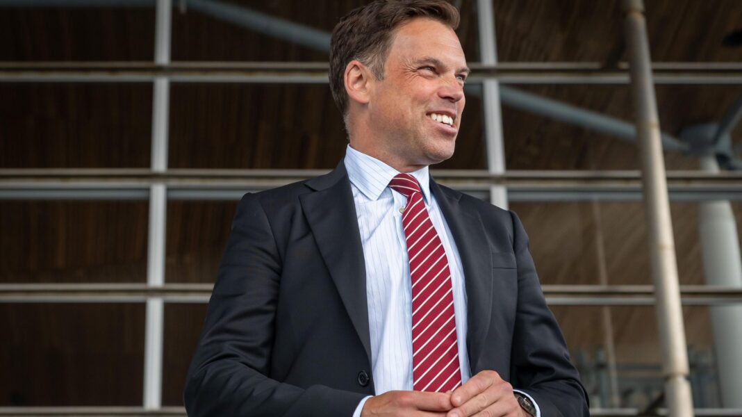 Labour calls for M4 relief road, seven years after axing the plan The image shows Ken Skates standing outside the Senedd. He is smiling and looking to his left. He is wearing a dark suit, white shirt and stripey red and white tie.