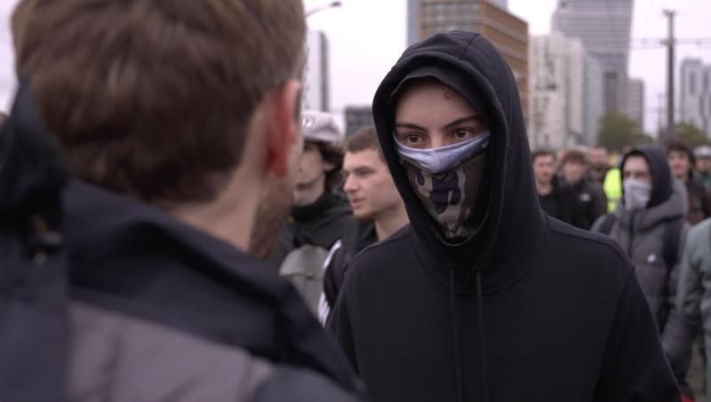 A masked teenage protester talks to a BBC correspondent in Paris. Photo: 24 October 2026