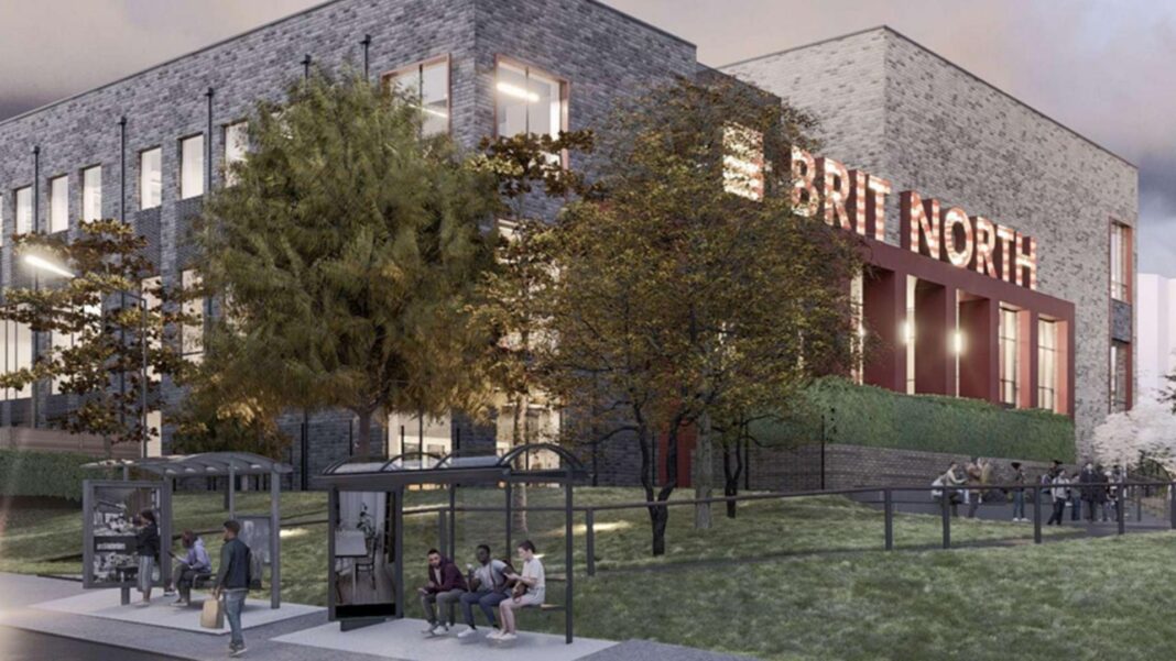 An artist's impression of Brit North - a large grey and black stone building with two bus stops outside and an area of grass and trees