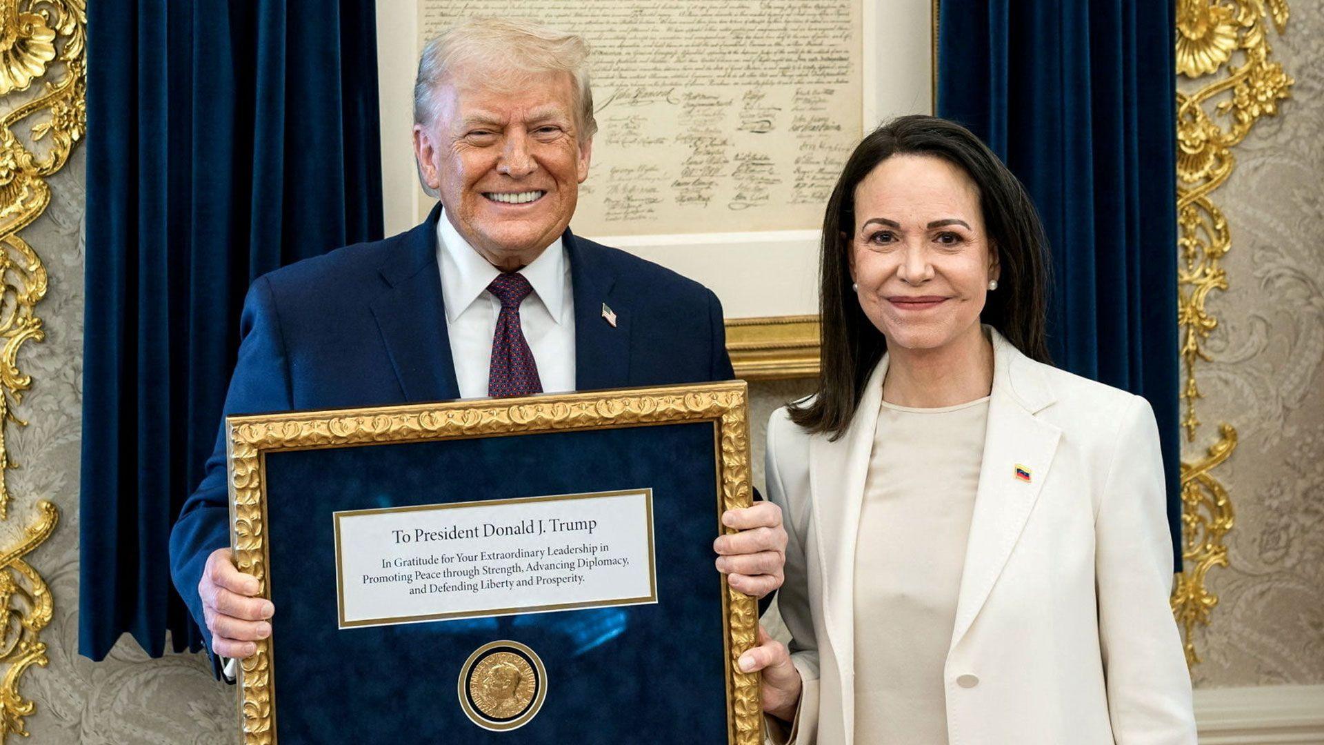 Donald Trump smiling broadly and holding up the Nobel Peace Prize