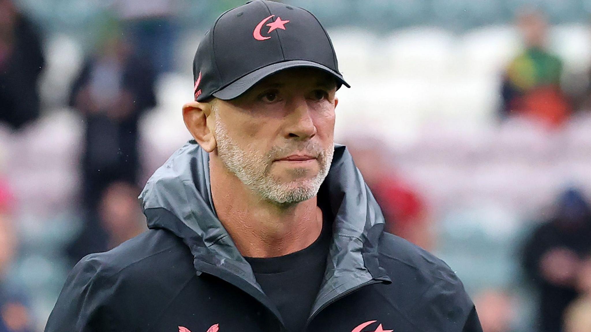 Brendan Venter in a Saracens hooded top and black Saracens cap