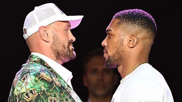 Tyson Fury faces off with Anthony Joshua at a news conference