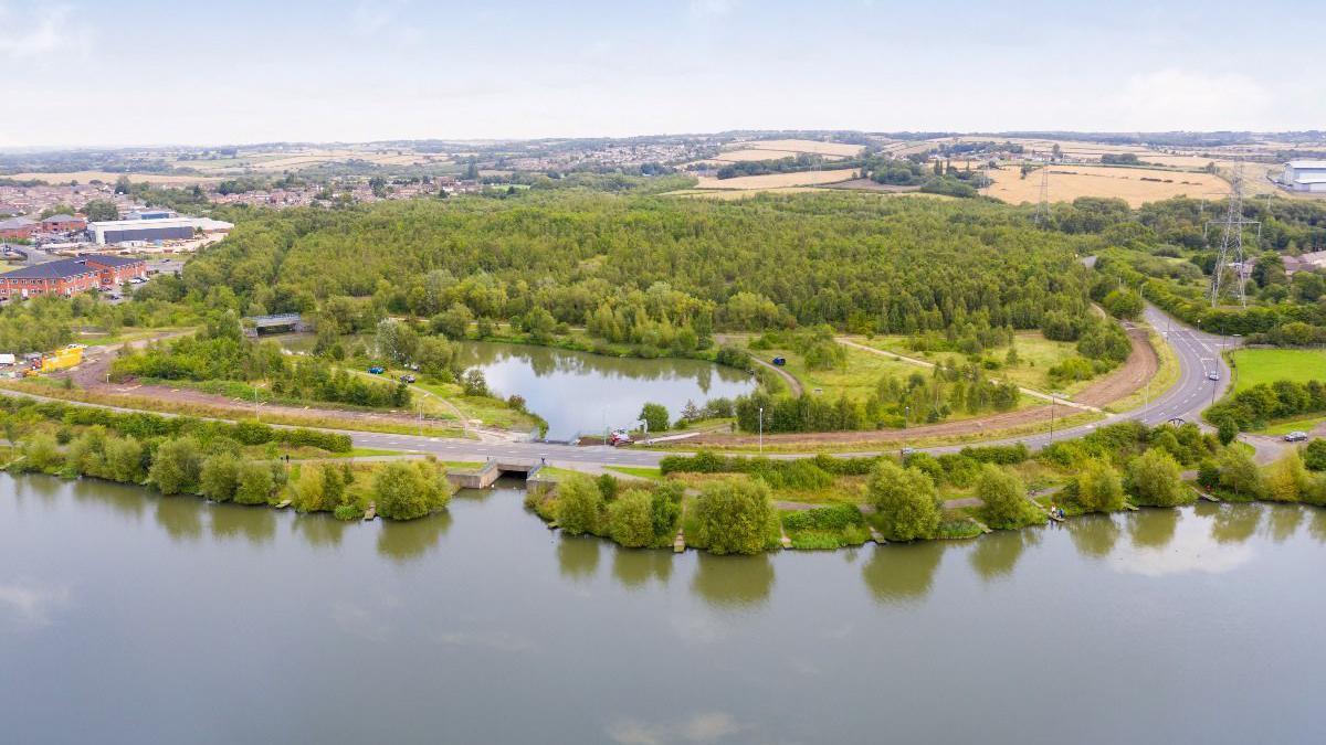A body of water surrounded by trees.