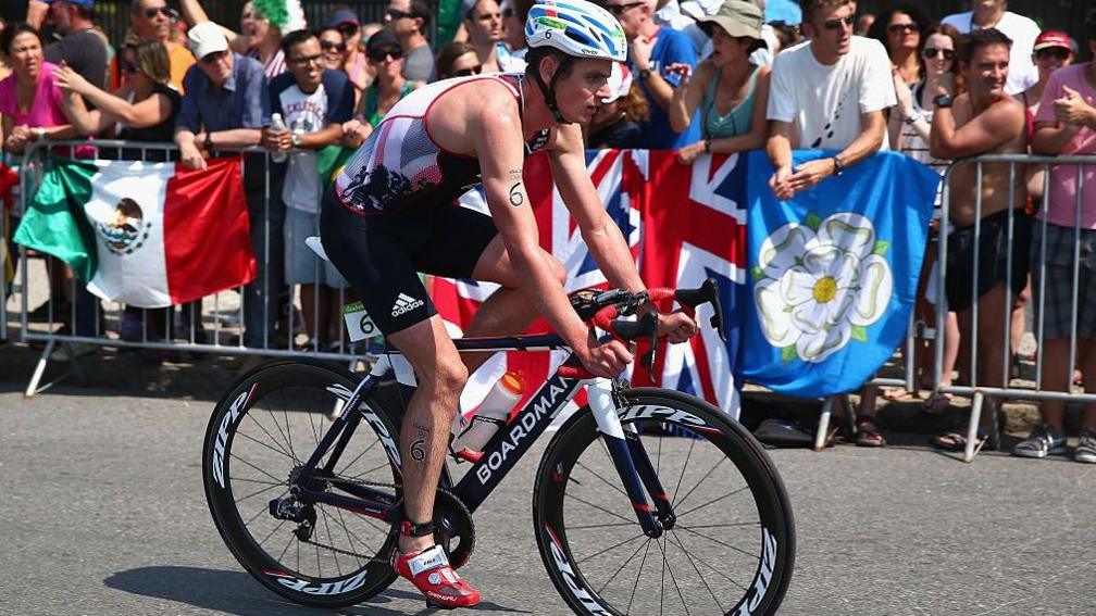 Jonny Brownlee riding his bike past a crowd at the 2016 Olympics