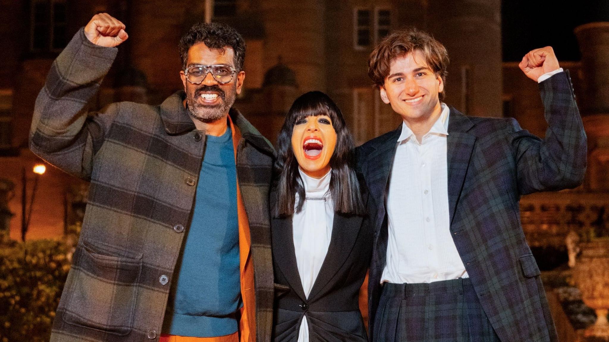 Romesh Ranganathan, Claudia Winkleman and Sebastian Croft with their arms around each other and celebrating