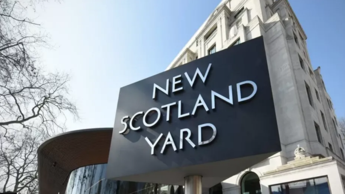 Outside New Scotland Yard - the large sign bearing its name can be seen