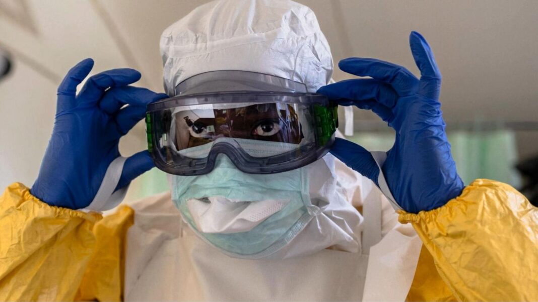 Kenya confirms second Ebola case as relative of country’s first victim A medical worker in Kenya dons Ebola protective gear: a yellow suit, blue gloves, white hood, an eye mask and face mask.