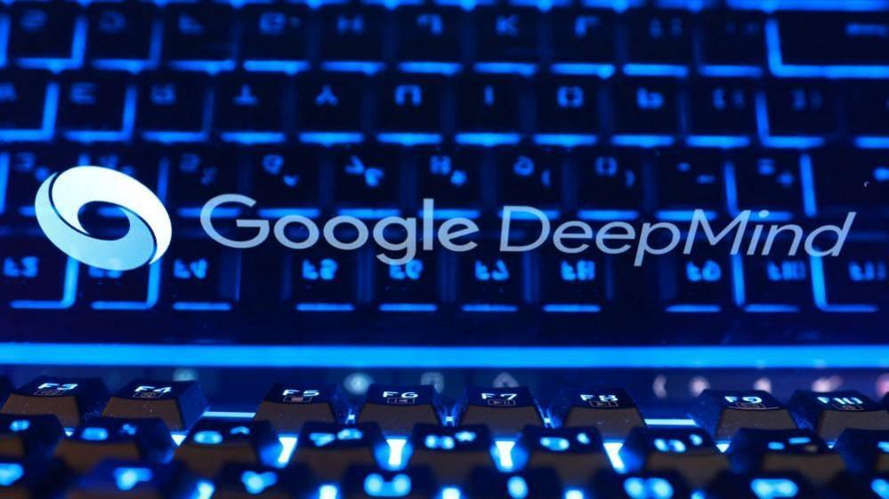 Stylized image of Google DeepMind logo on a screen with the blue lights of a keyboard reflecting on it.