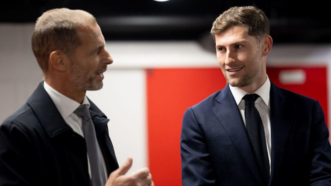 Ben Davies (left) pictured alongside Uefa president Aleksander Ceferin at the FAW's headquarters in Hensol
