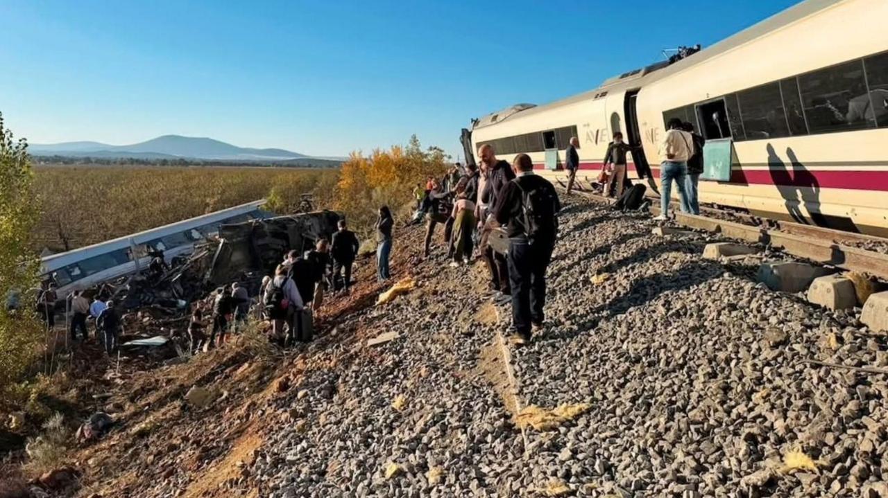 Wide shot showing a derailed train carriage in an embankment