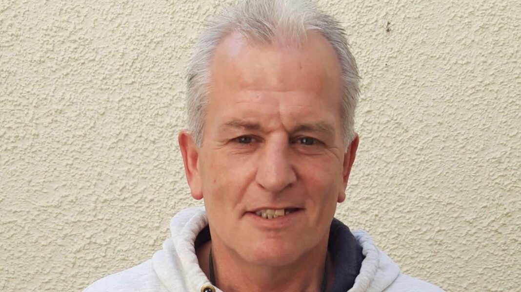 Babydoll singer becomes first Welsh artist to top UK singles chart in 15 years Clifford Foster stands in front of a white wall. He wears a white hoodie, has silver hair and brown eyes and smiles at the camera.