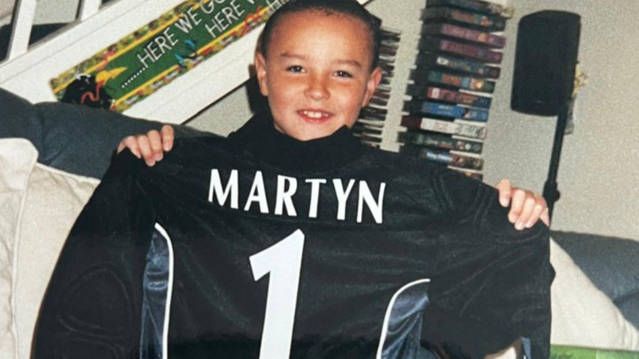 Former Barton Town goalkeeper James Hitchcock pictured as a youngster holding up a shirt with ex-Leeds United goalkeeper Nigel Martyn's name on the back