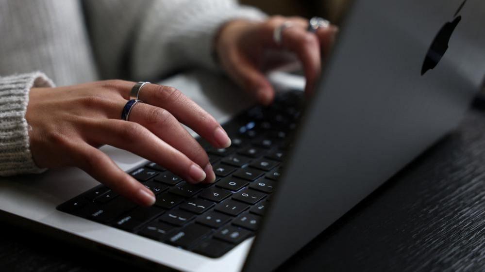 A person works on their laptop at a cafe in London, Britain, October 21, 2026