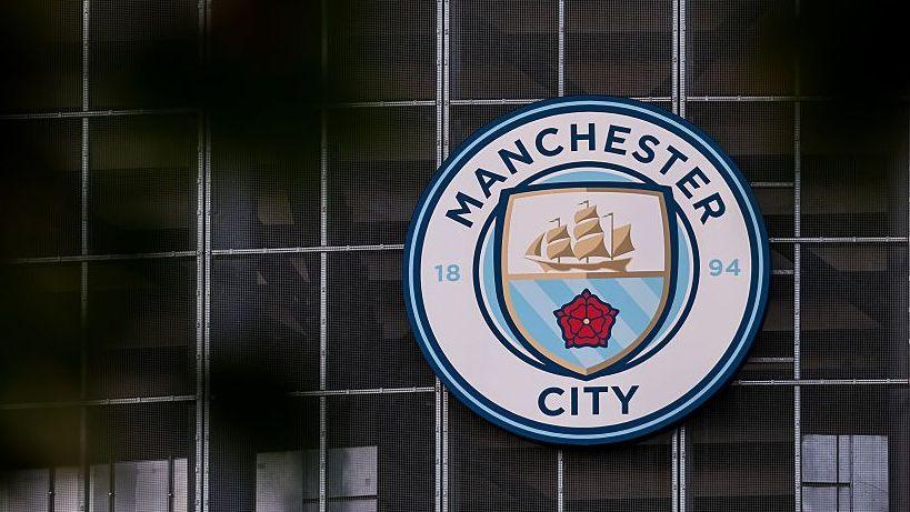 Manchester City logo on the side of Etihad Stadium