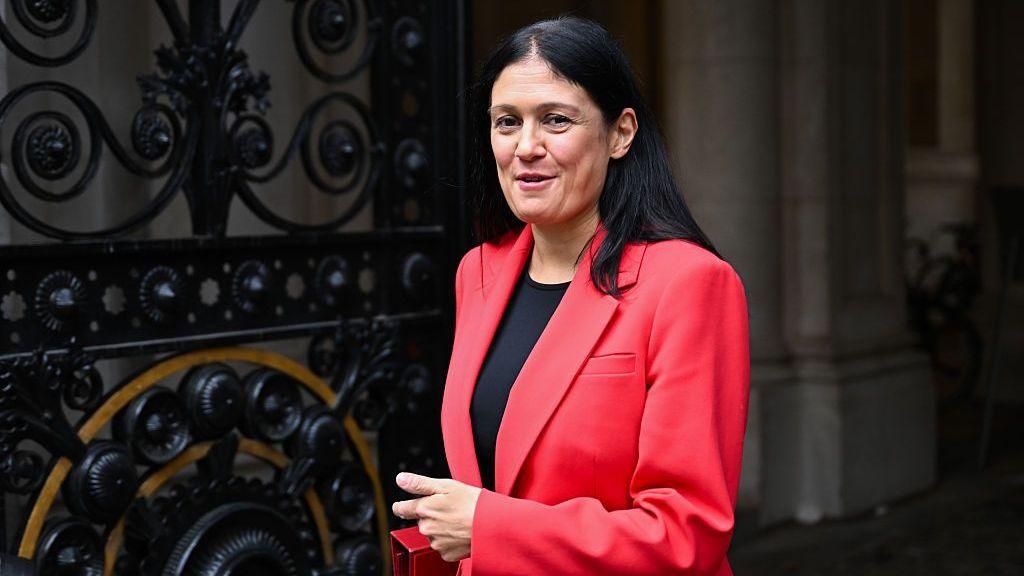 Lisa Nandy wearing a pink blazer and black t shirt.