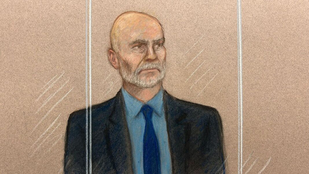Ex-Met officer from Couzens unit guilty of rape Court sketch of Mark Tyrrell a bald man with a grey beard, wearing a dark suit, blue shirt and blue tie, standing behind the glass of a dock