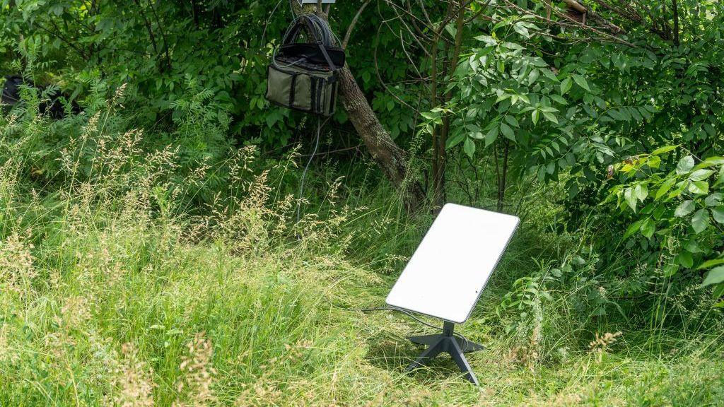 A terminal in green bushland. It looks like a large piece of paper on a tripod.