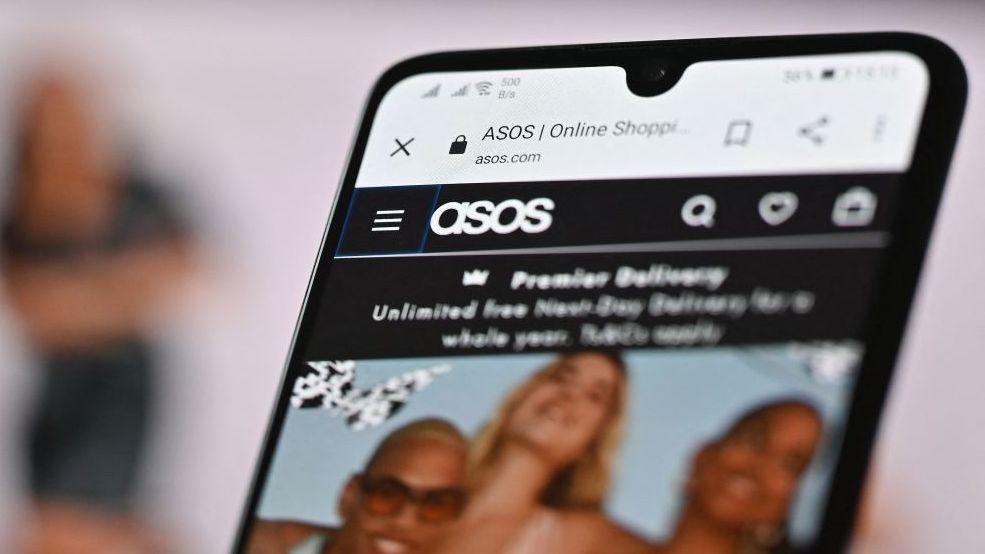 Asos website on smartphone screen.
