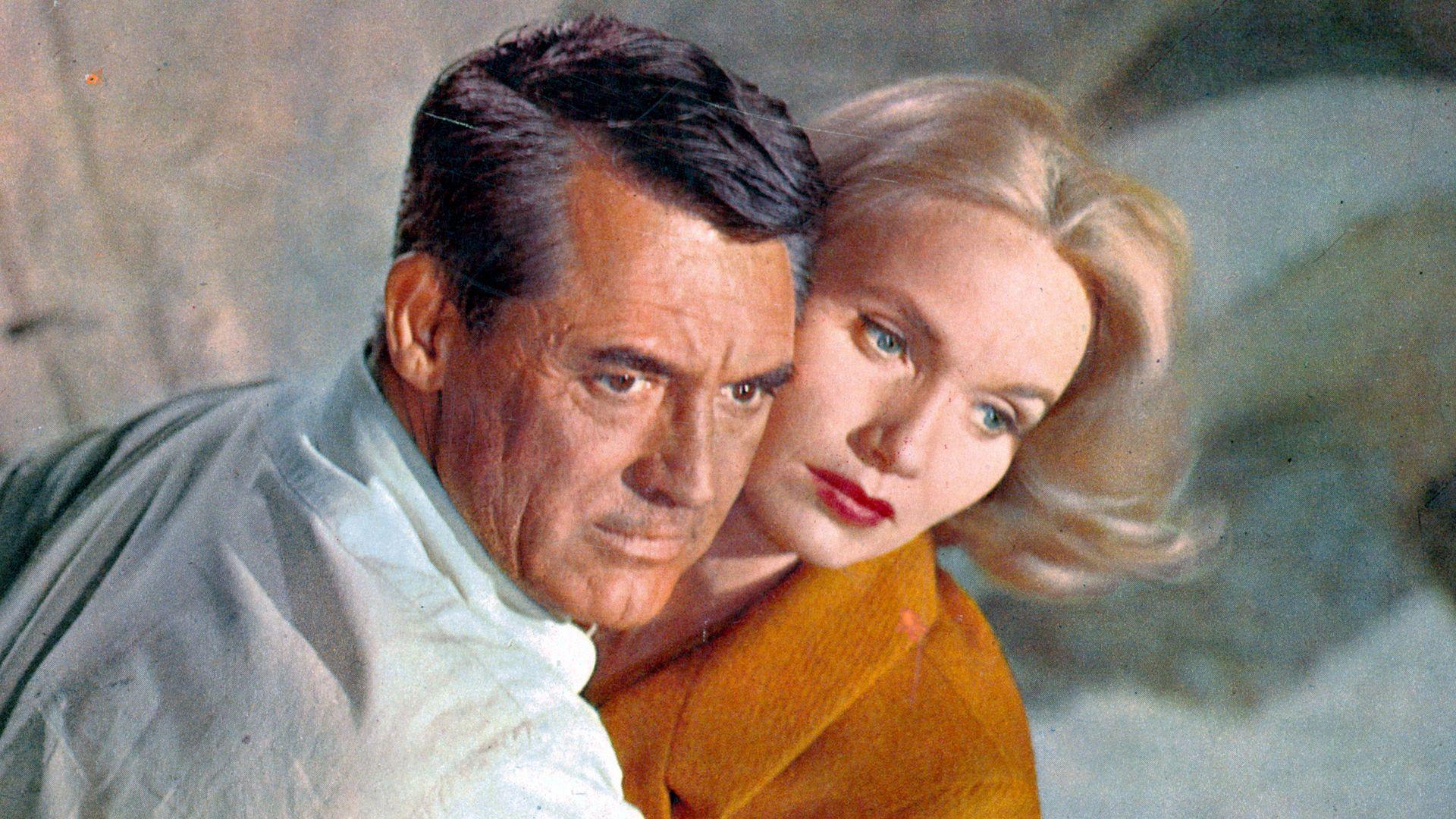 Cary Grant holding Eva Marie Saint in a scene from the film 'North By Northwest', 1959