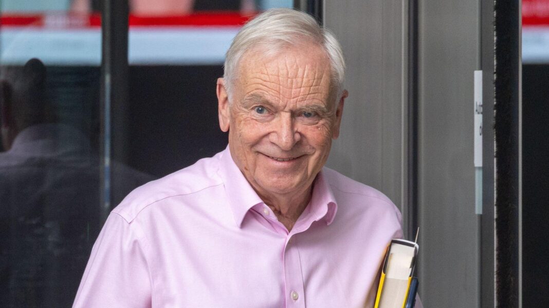Author and former politician Jeffrey Archer dies aged 86 Lord Archer in a pink shirt, smiling and holding a copy of his book