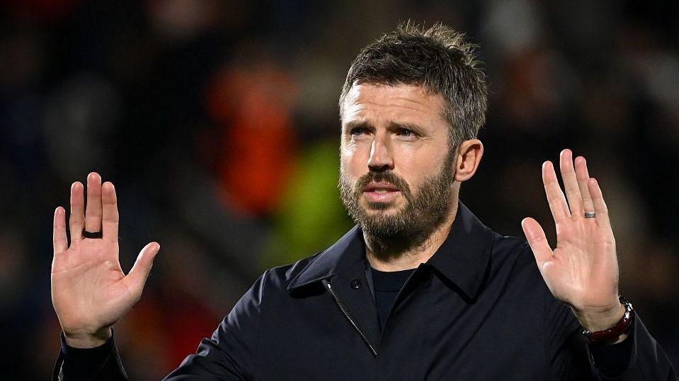 Manchester United manager Michael Carrick holds up his hands