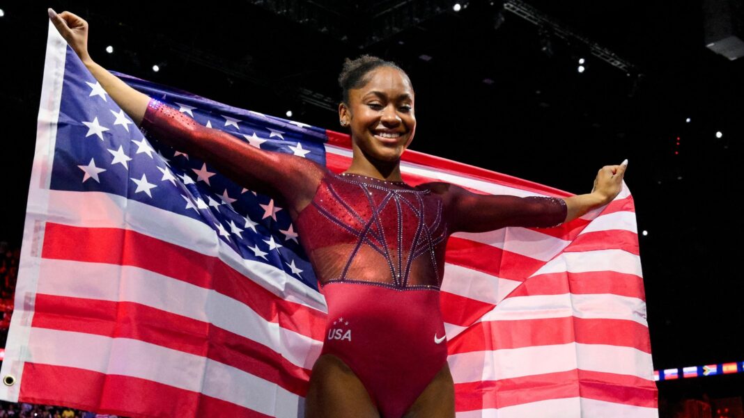 Skye Blakely holds the stars and stripes aloft after winning gold