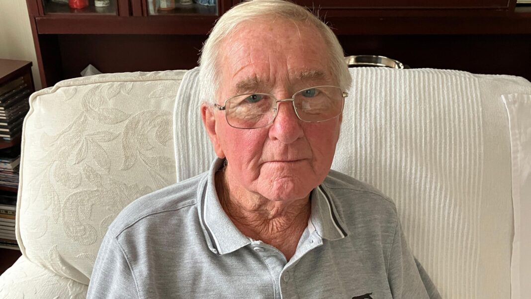 Heart attack patient, 83, had to drive four hours for hospital appointment A photo of an older man - grey hair and glasses. He's sitting on a cream coloured sofa and is wearing a grey polo top