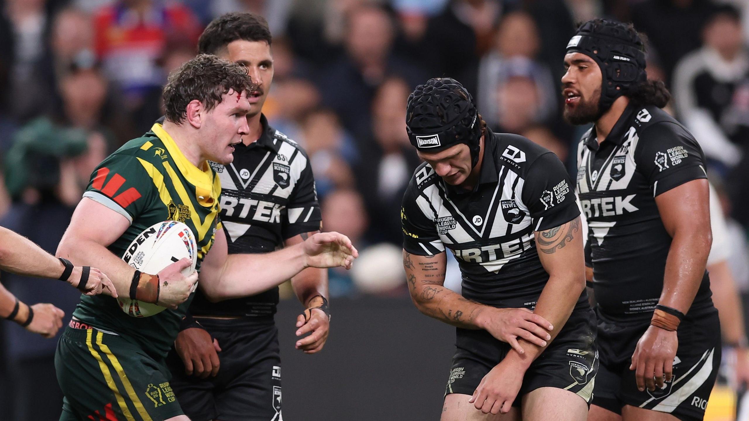 New Zealand's Kalyn Ponga feels his injured left arm during the World Cup game against Australia