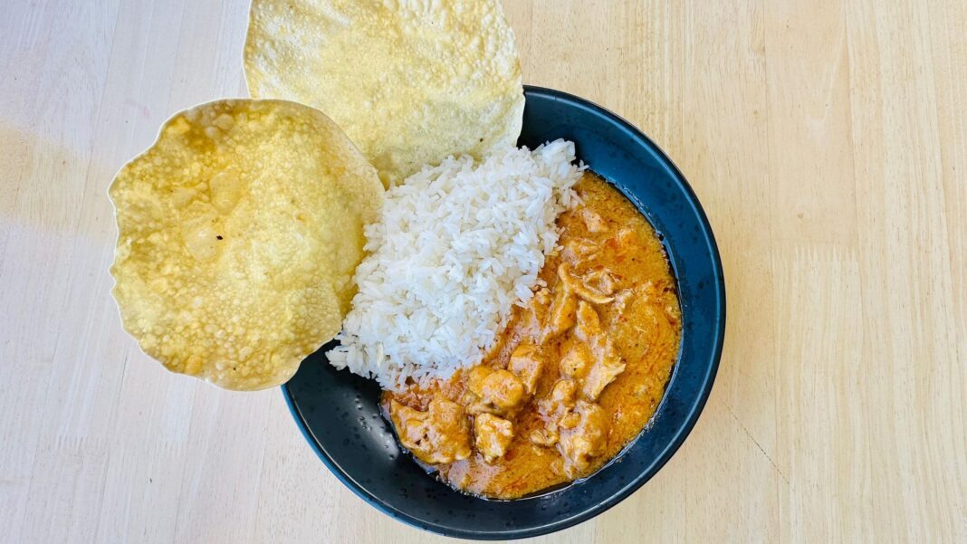 A stock photo of curry, rice and papadams