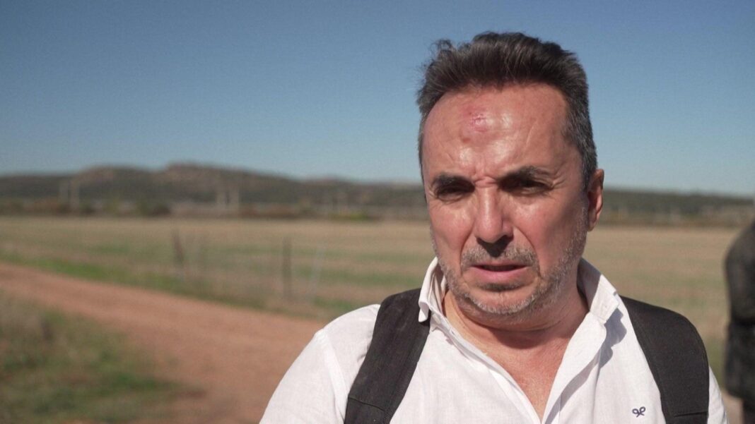 Bloodied, dazed and angry – how passengers’ rail journey turned to disaster in Spain A man with short hair and a beard - with a bruise on his forehead - speaks to the media; he is wearing a white shirt with the black straps of what appears to be a backpack visible