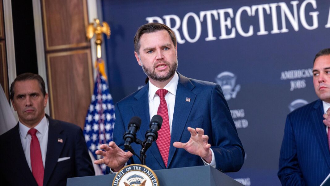 White House blocks Microsoft from foreign worker hiring program Vice President JD Vance standing at a podium and gesturing, wearing a blue suit, white shirt, and red necktie.