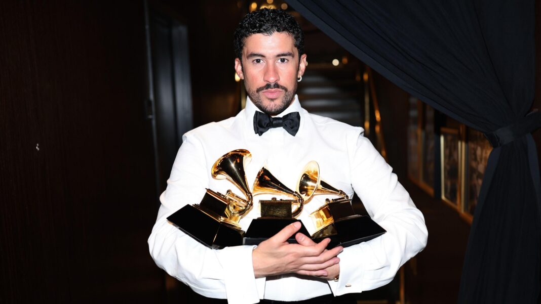 K-pop giants Stray Kids join BTS in boycotting the Grammys Bad Bunny wears a white shirt with a black bow tie. He is holding numerous Grammy Awards.