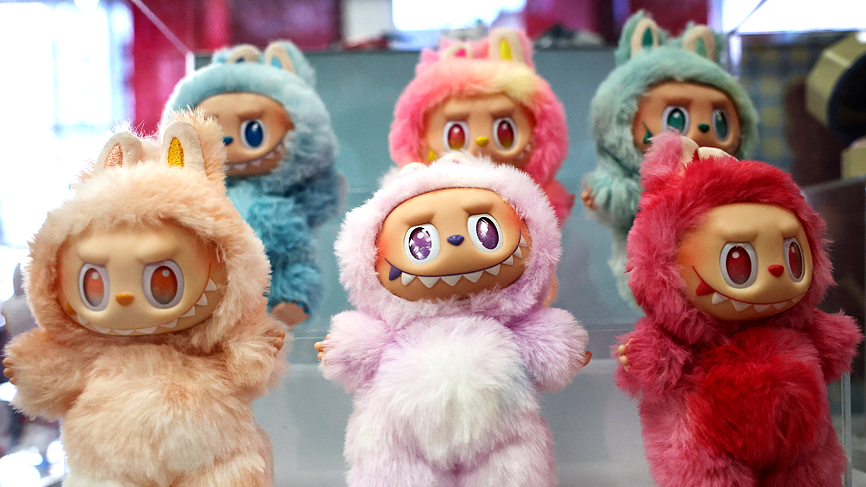Labubu dolls of various colours including pink, deep red and beige on displayt at Pop Mart's Skullpanda pop-up shop in Manhattan in New York City
