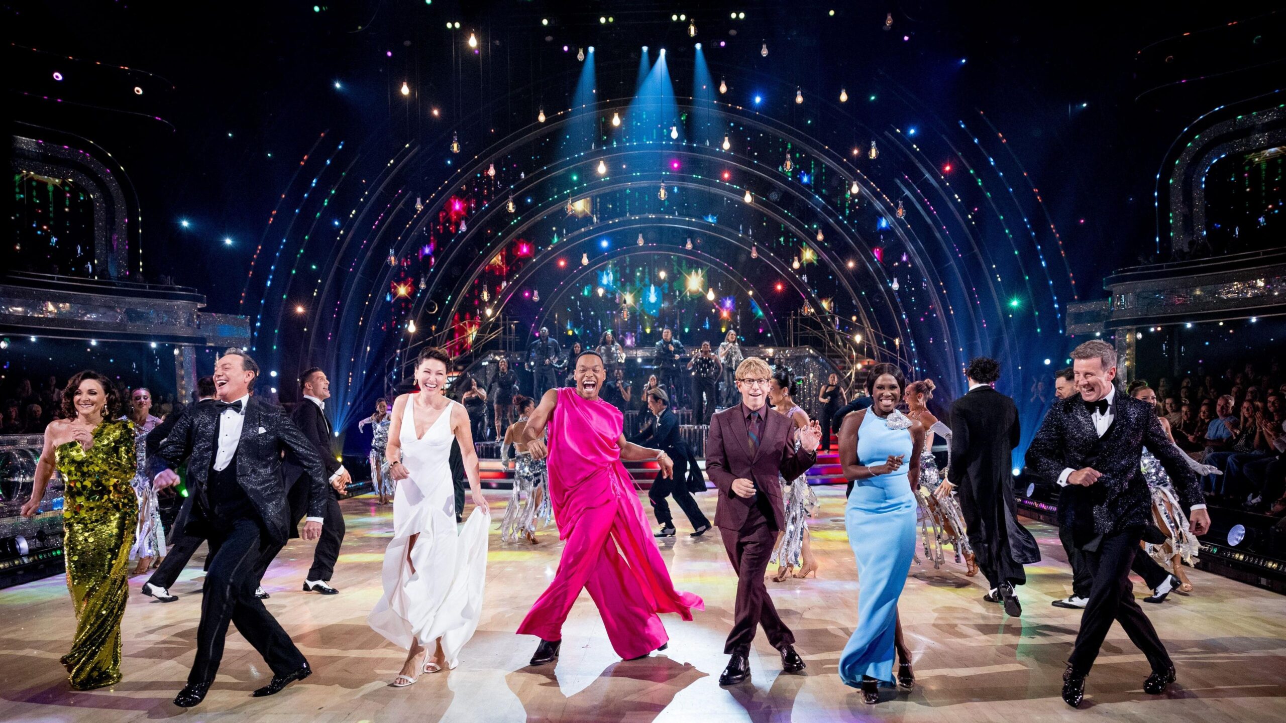 Strictly hosts and judges dancing in a line in the Strictly studio