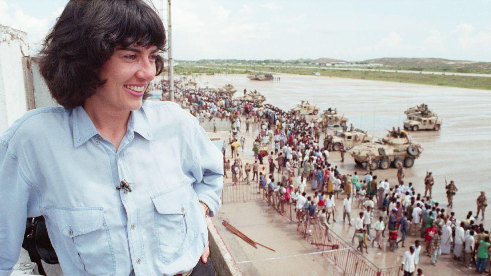 CNN Correspondent Christiane Amanpour covers the US-led peacekeeping operation in Mogadishu in 1992. From a tower she watches and smiles at Somali civilians crowding around the US Marines.