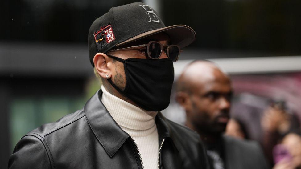 R&B singer Chris Brown arriving at Southwark Crown Court, south London, for sentencing after he pleaded guilty to affray following a bottle attack on Abraham Diaw in February 2023. He is wearing a black mask, , black cap, white poloneck, black jacket and sunglasses.